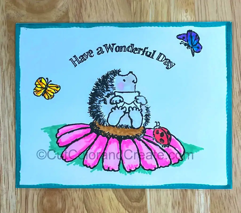 A delightful cardmaking project featuring a cheerful hedgehog perched on a vibrant flower.