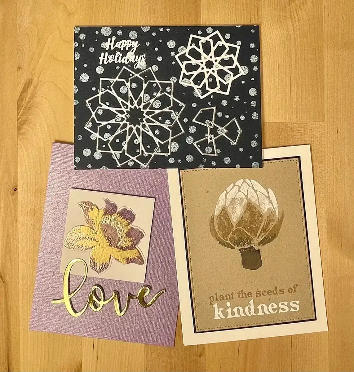 Three greeting cards with unique designs featuring heat embossing techniques.