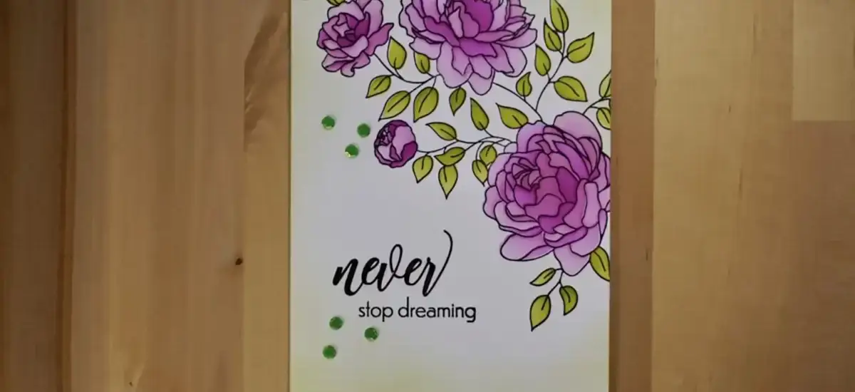 A card with purple flowers on it, blended with stencils.