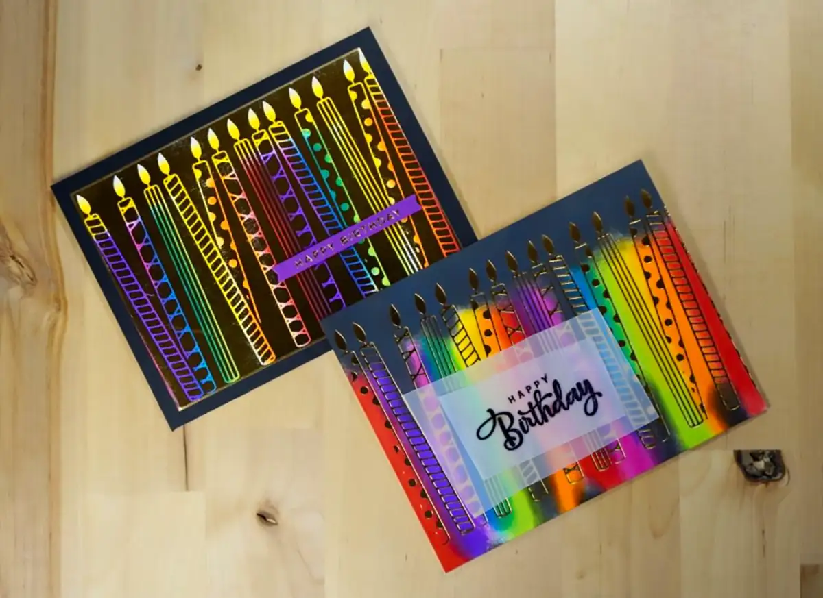 Two colorful birthday cards featuring Spellbinders' New Release on a wooden table.
