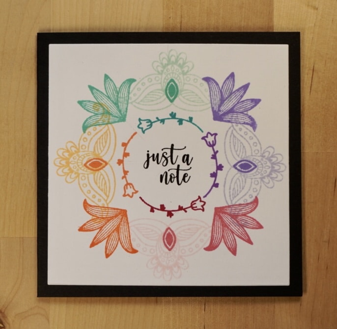 Beautiful stamped rainbow wreath card.