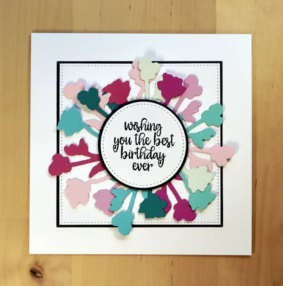 Beautiful unique wreath card using die-cuts with pinks and teals.