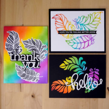 Three colorful cards made from 1 die-cut on a wooden table.