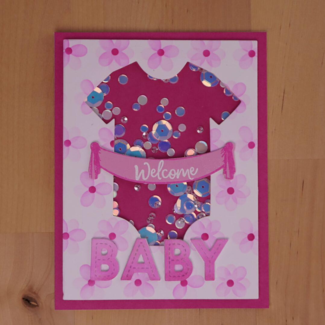 Darling homemade shaker card for celebrating a new baby with blended letters and a pretty stenciled patterned paper.