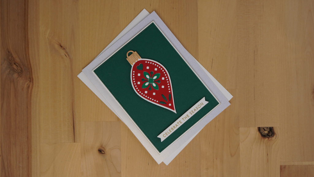 Christmas card made with nordic Spellbinders ornament dies and traditional Christmas colors.