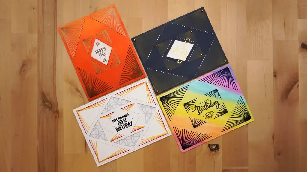 Four colorful cards with stitching on a wooden floor.