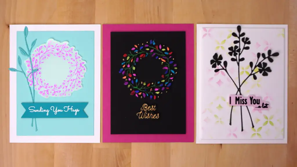 Three greeting cards with foil flowers and dies-cut words on them.