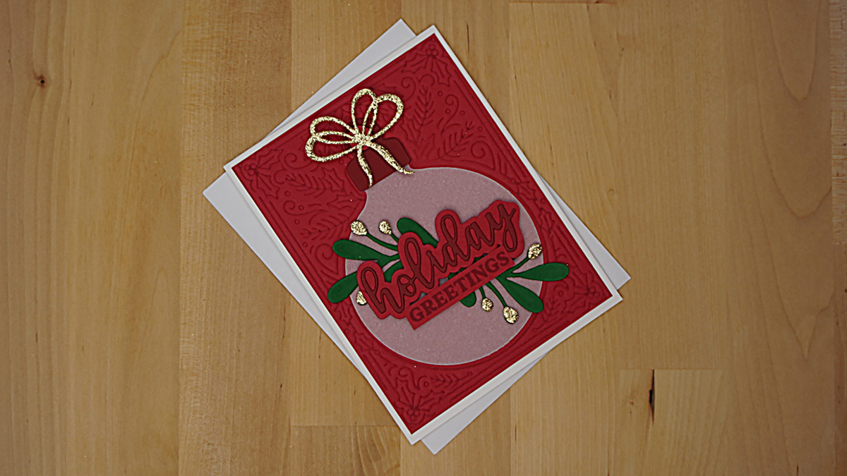 A very special Christmas card with a decorated ornament that swings aside to give a secret message.