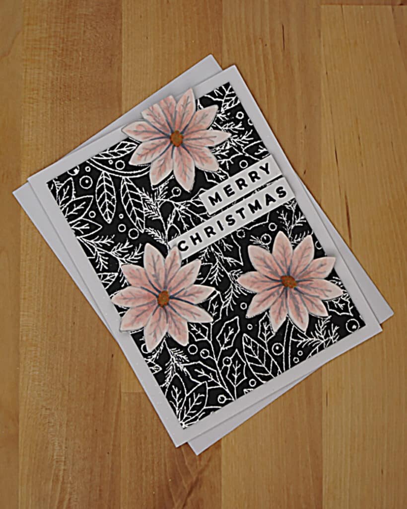 Pink poinsettia Christmas card with shiny silver embossing.