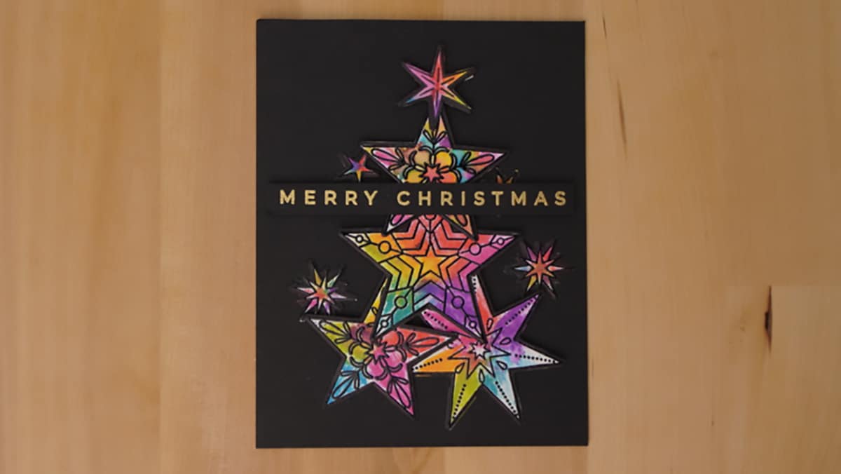 Gorgeous rainbow stars are front and center for Day 24 of the Twenty-Five Days of Christmas Cards.