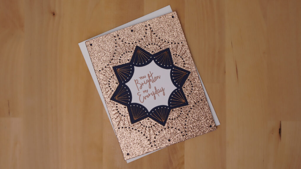 Spellbinders' January Stitched Die of the Month is used to create this glittery card to brighten someone's day.