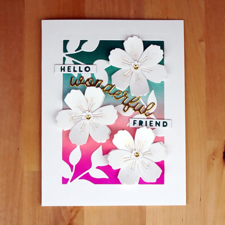 Lovely Card for a friend featuring white die-cut flowers in front of a pretty blended background in teals and pinks.