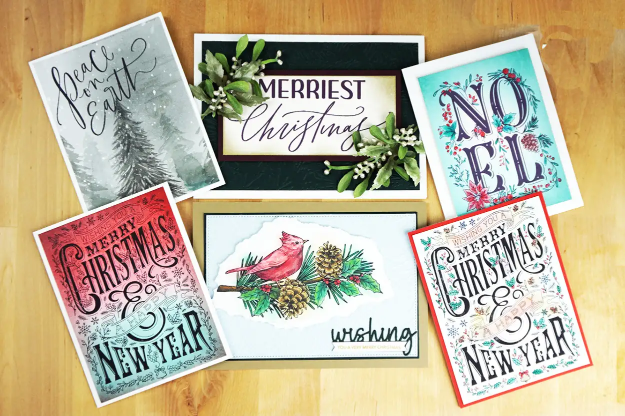 A set of 6 BetterPress Christmas cards with hand lettering on them.