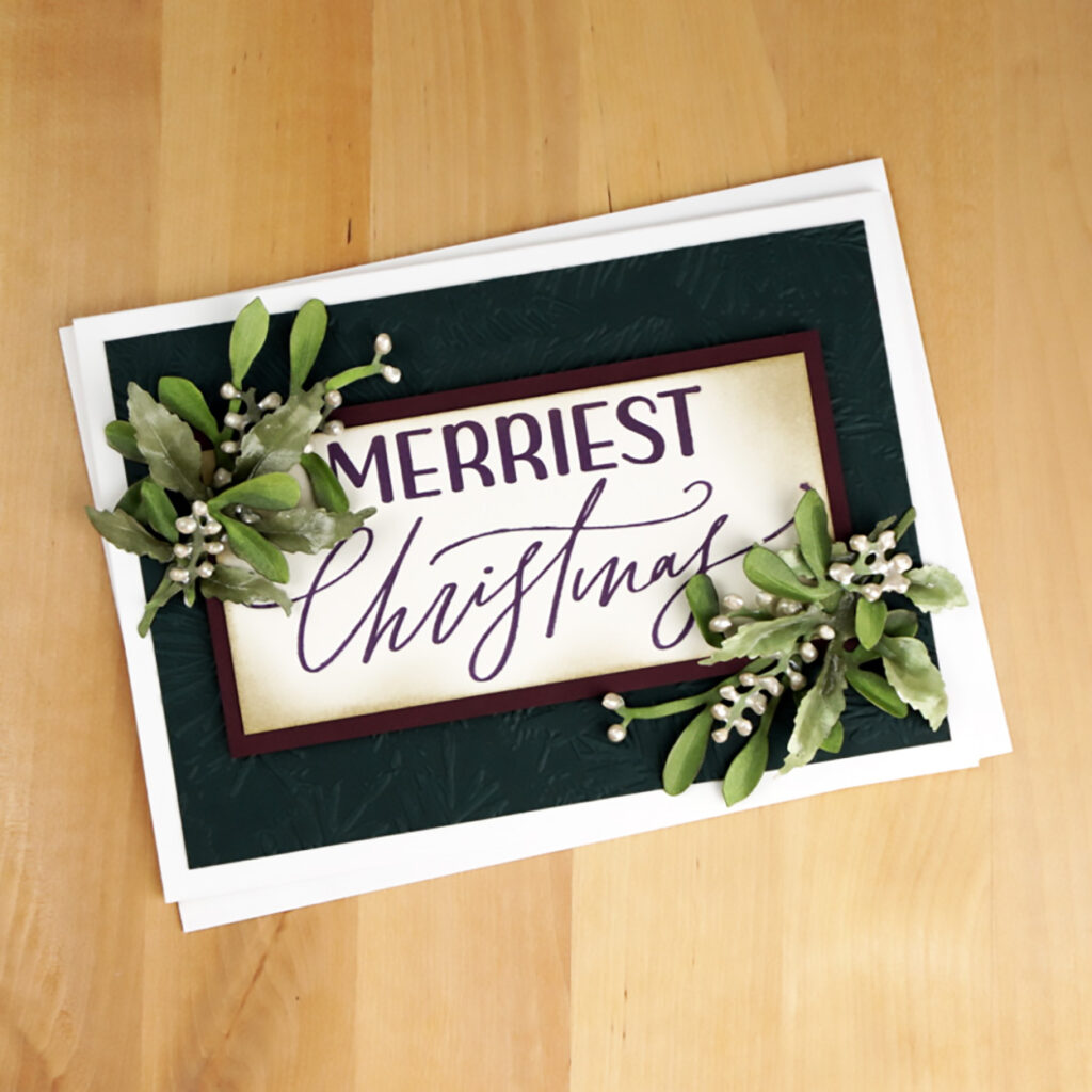 Card 6 of 6 BetterPress Christmas cards is an elegant card in deep gem tones and features life like mistletoe and winterberry.