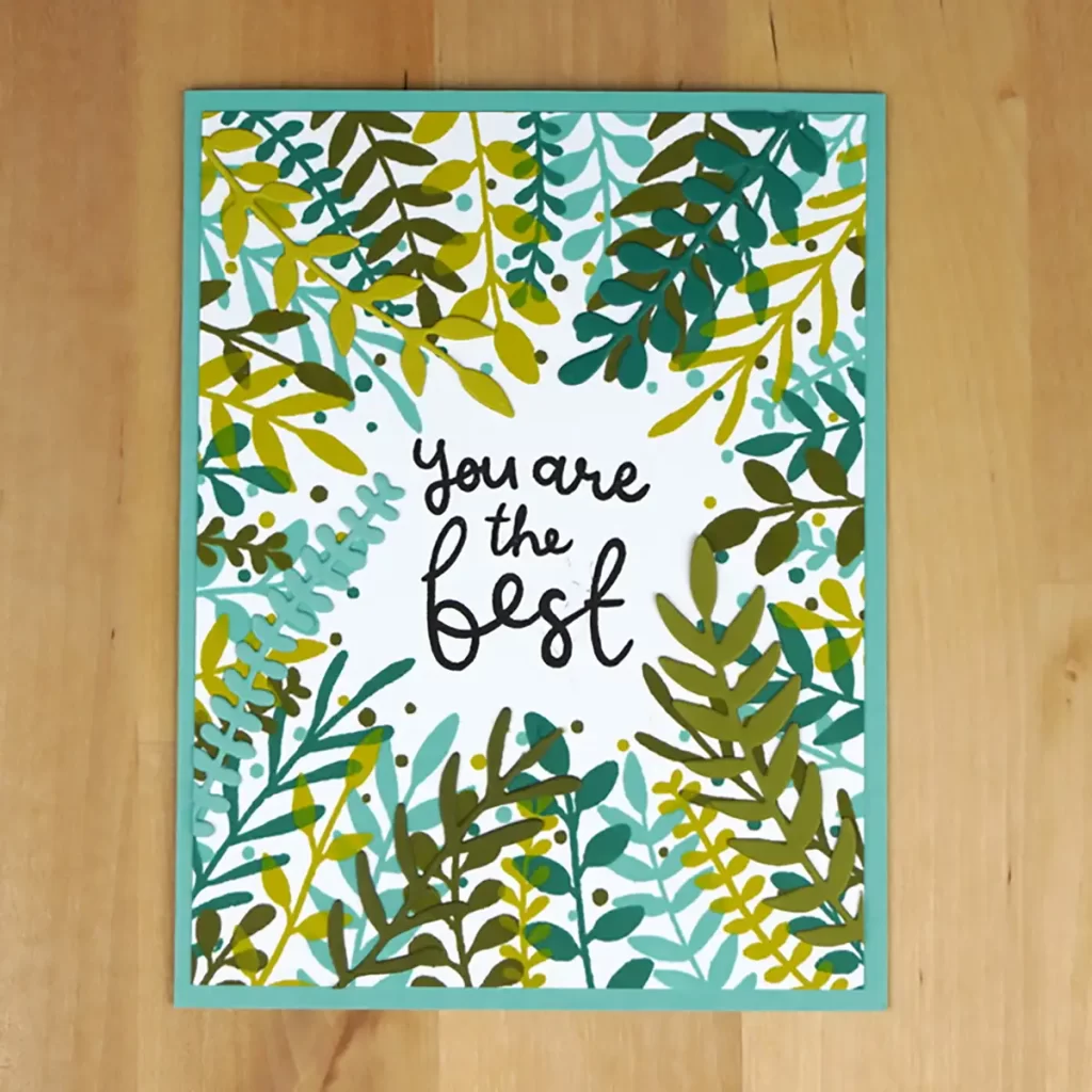 Pretty card stamped in various shades of greens in a wreath shape around the sentiment, 