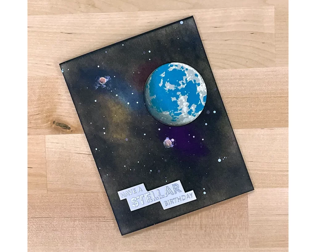 Out-of-this-world card featuring ink blending with dark colors and a stenciled earth.