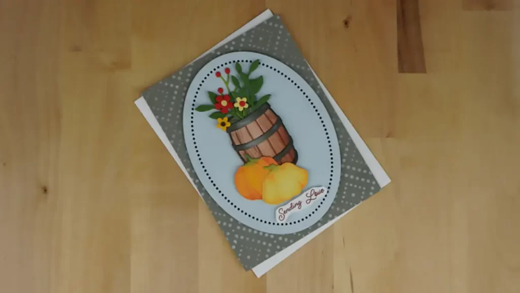 Beautiful card created using products from the new Spellbinders release, Country Roads.  The card features a barrel filled with flowers with gourds sitting in front.