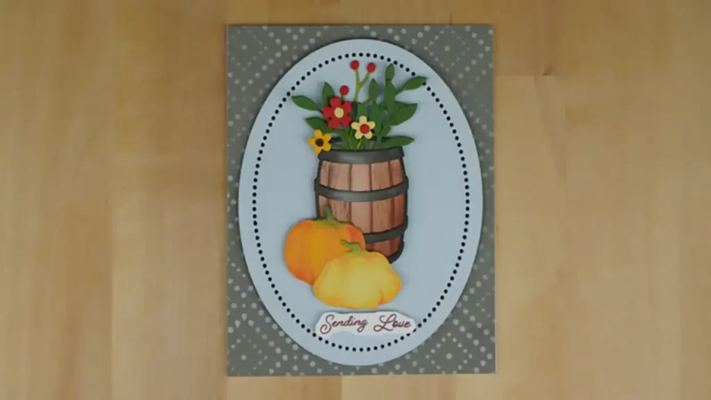 Beautiful card created using products from the new Spellbinders release, Country Roads.  The card features a barrel filled with flowers with gourds sitting in front.