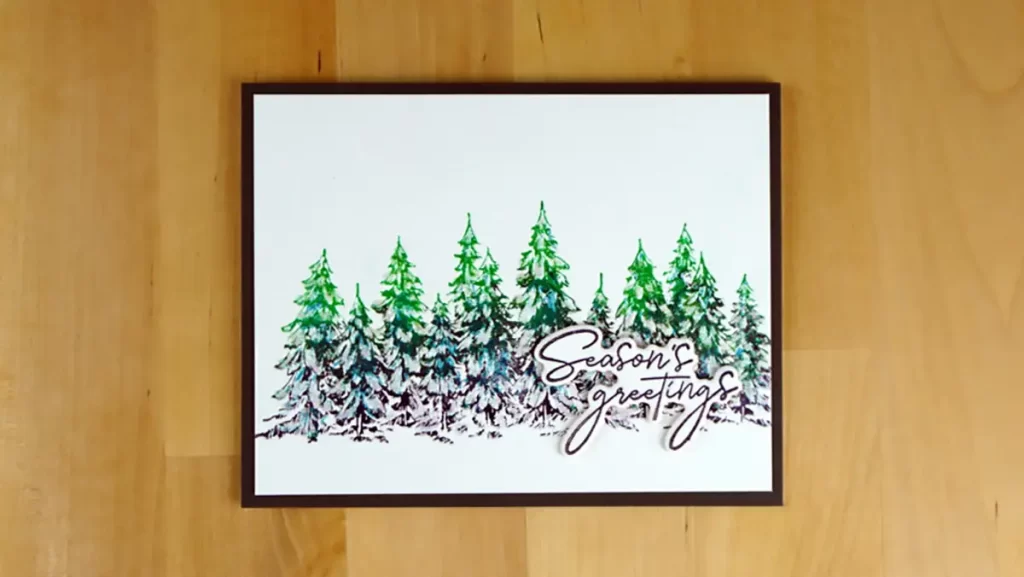 Almost clean and simple, this card features a BetterPress Evergreen forest colored in greens, teals, and black.