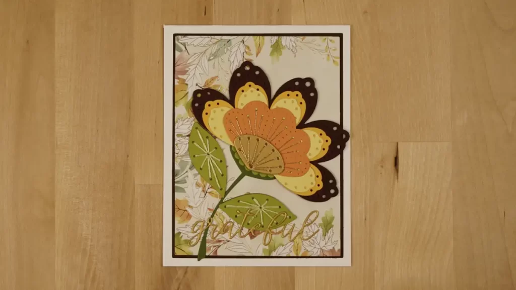 Autumn-colored card featuring die-cuts and stitching using Spellbinders' November Stitching Die of the Month.