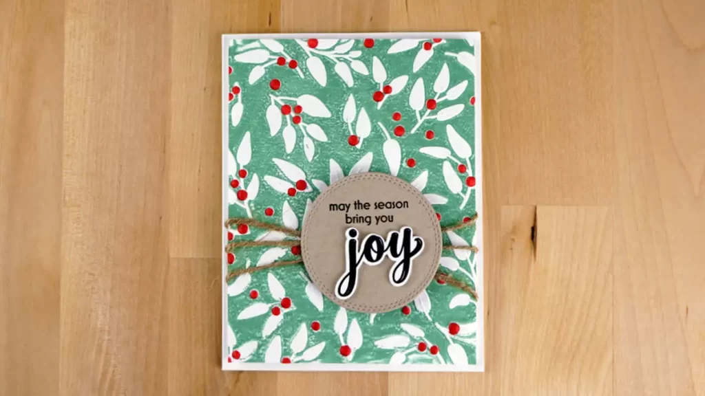 Joyfully Celebrate Kraft Joy card embossed and stenciled with Altnew's Joyful Greenery from their October 2023 release.