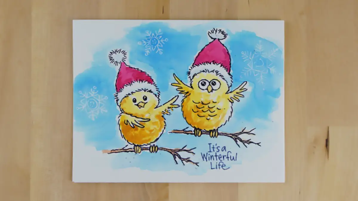 A unique card for winter or Christmas featuring cute snowbirds watercolored over a snowy background.
