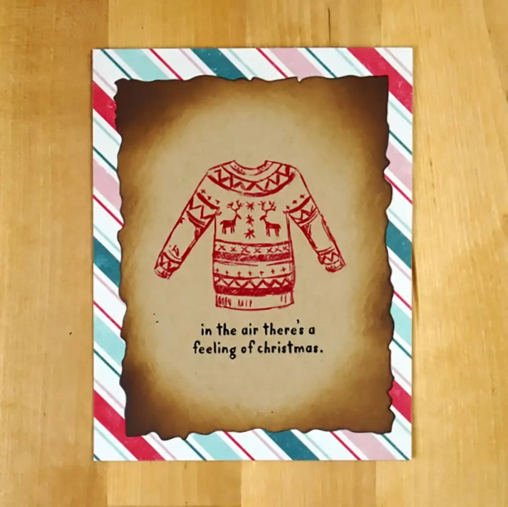 A festive Christmas card with a cozy sweater design.