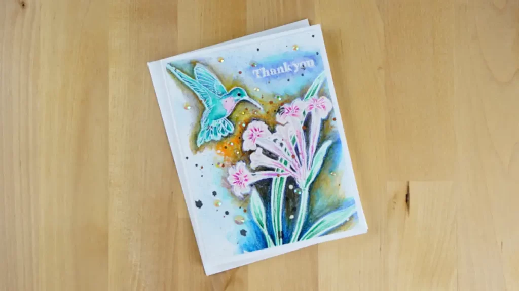 A card with a hummingbird among flowers printed on it.