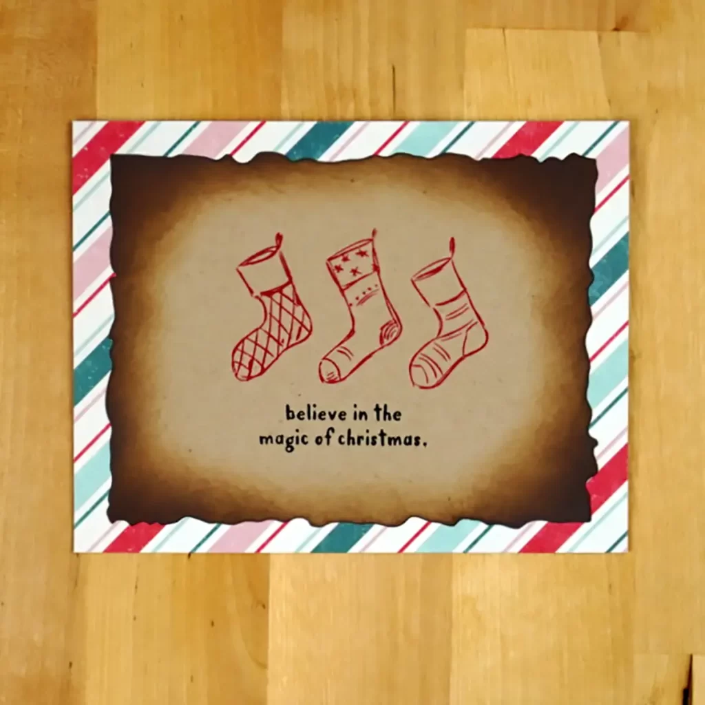 A festive Christmas card featuring three stockings and the sentiment to "believe in the magic of Christmas.