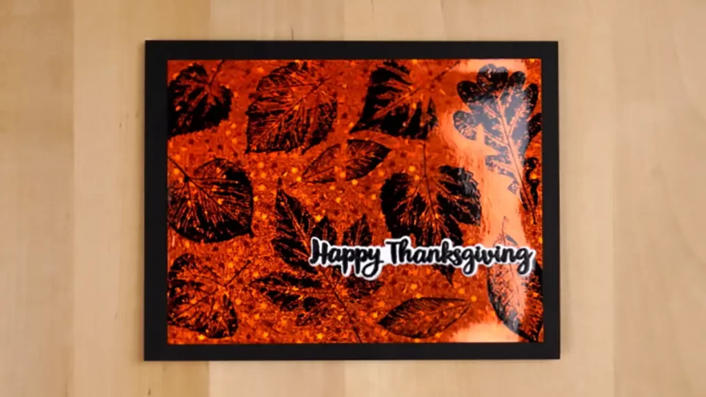 A happy thanksgiving card with black and orange leaves.