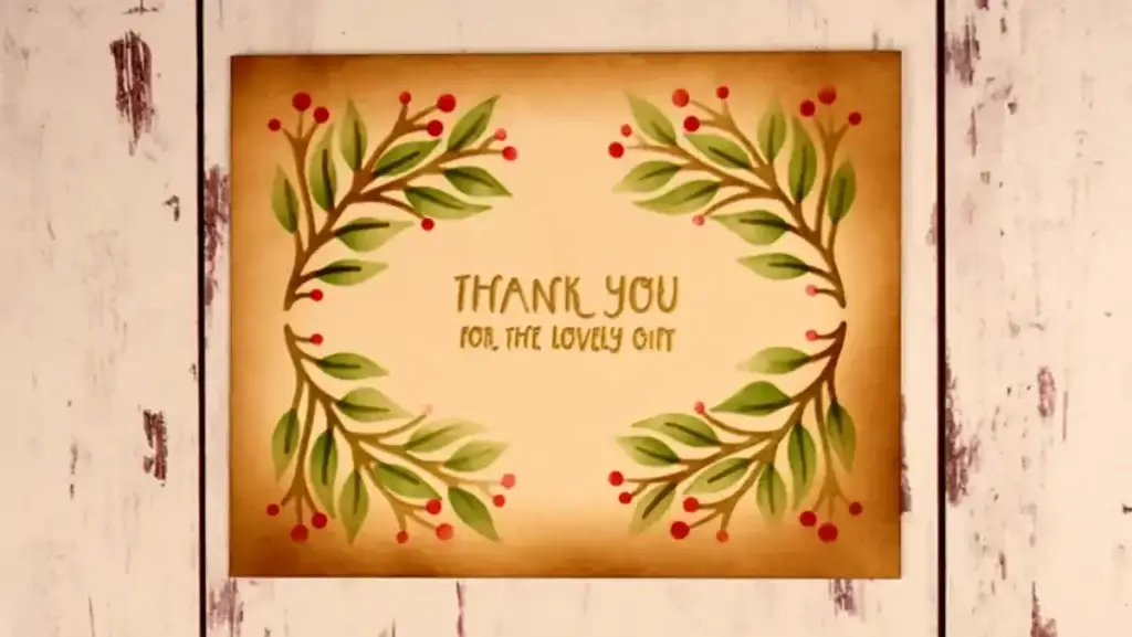 A stenciled thank you card with greenery and red berries 