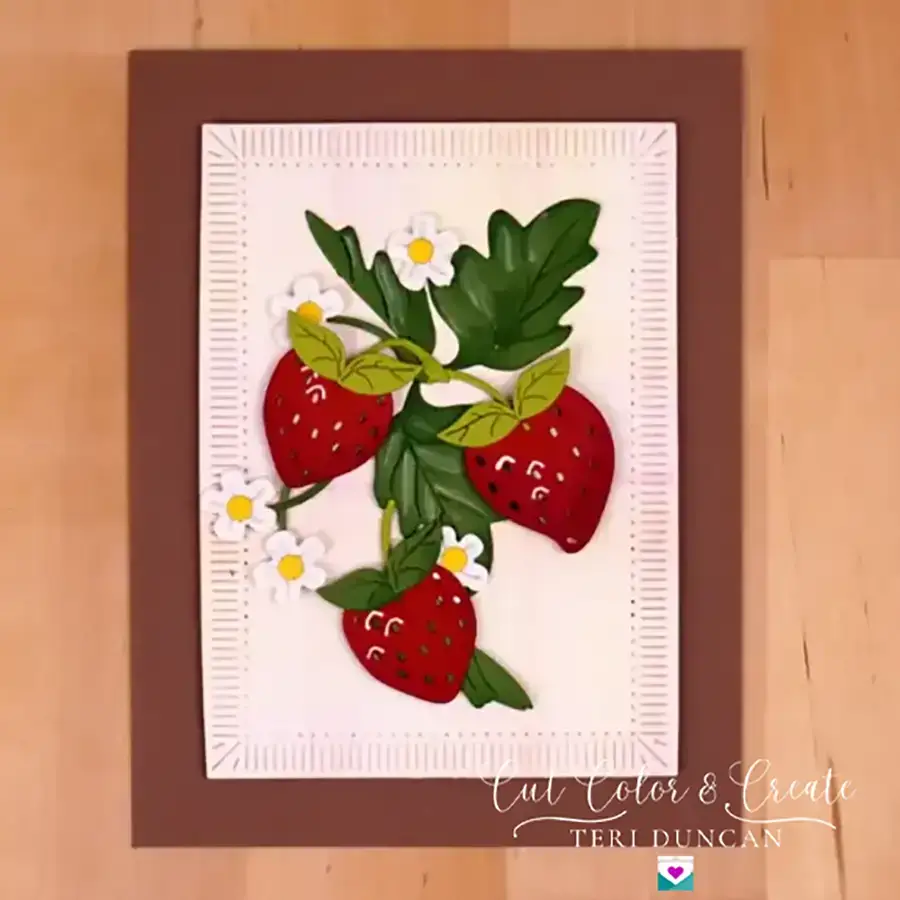 A handmade greeting card with a strawberry bunch on it.