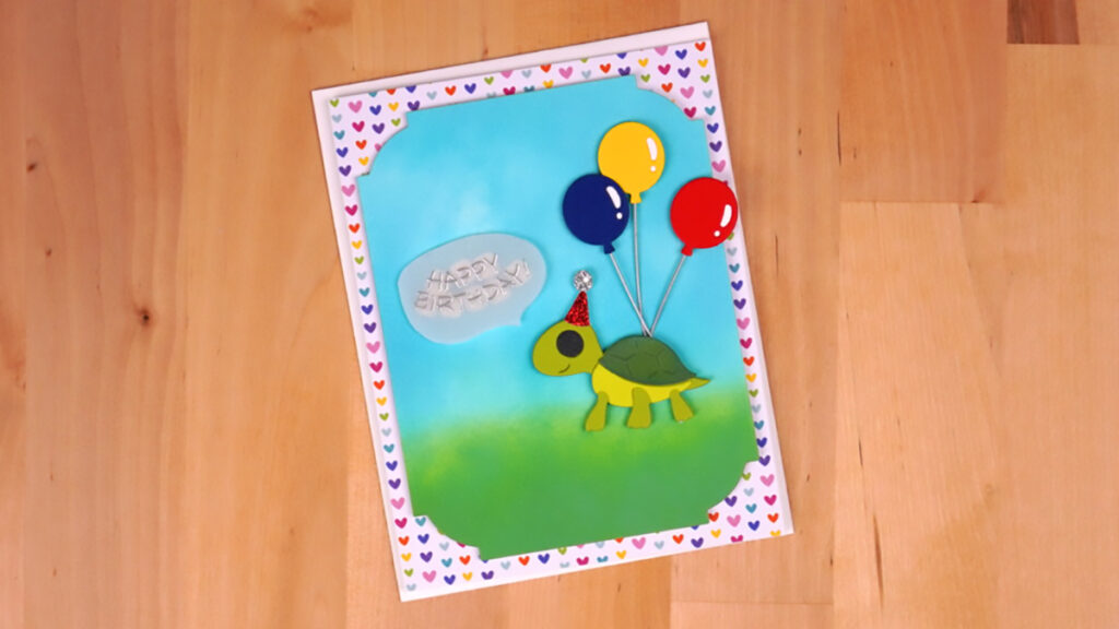 A birthday card with a turtle and balloons.