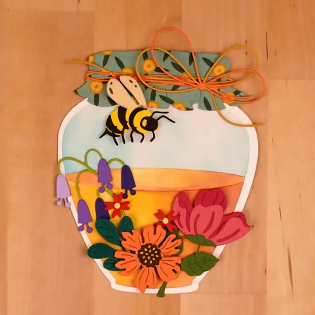 A card with a bee and flowers in a jar.