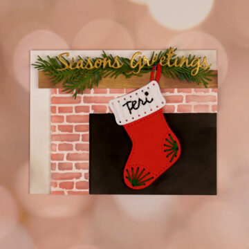 A Stitchmas card with a stocking hanging from a fireplace.