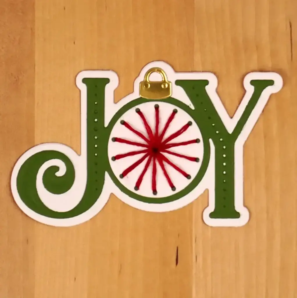 A christmas ornament with the word joy on it.