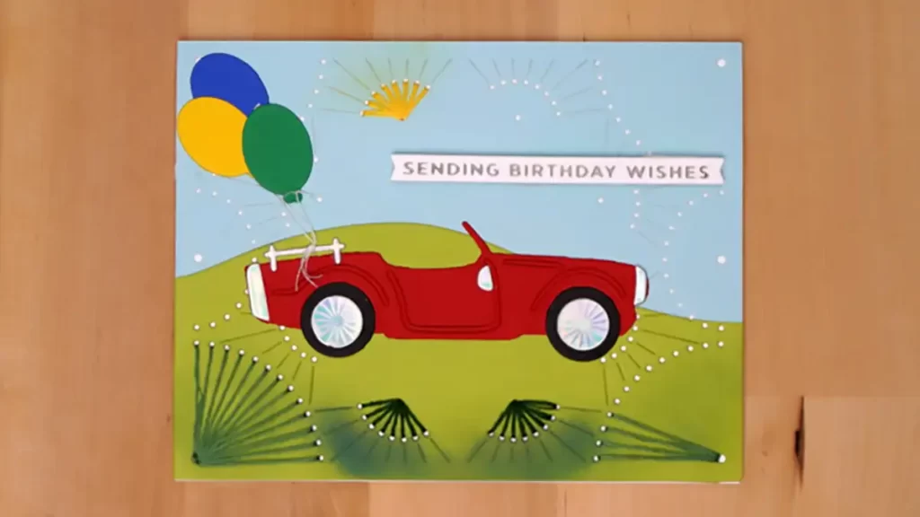 A birthday card featuring a vibrant red car and balloons to help you "Get more" joy and excitement on your special day.