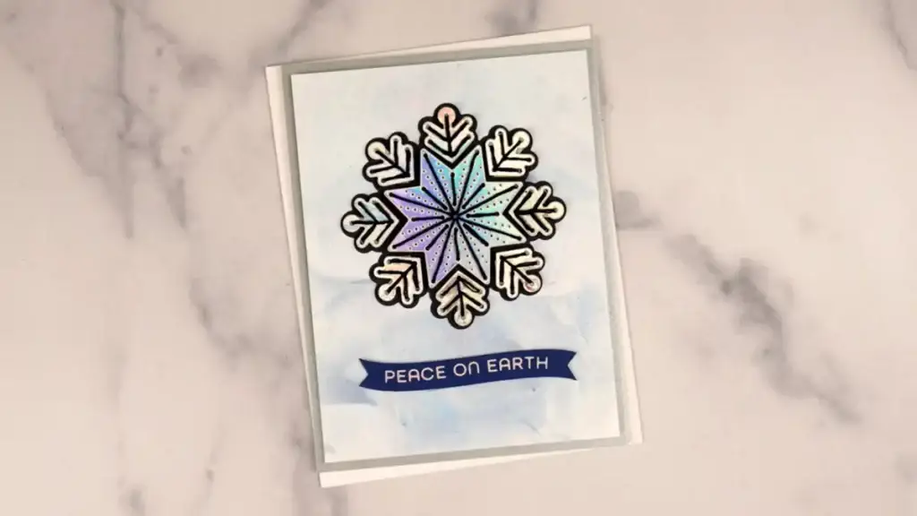 A card with a stitched snowflake on it.