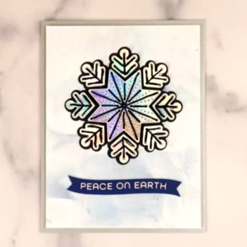 A card with a stitched snowflake on it.