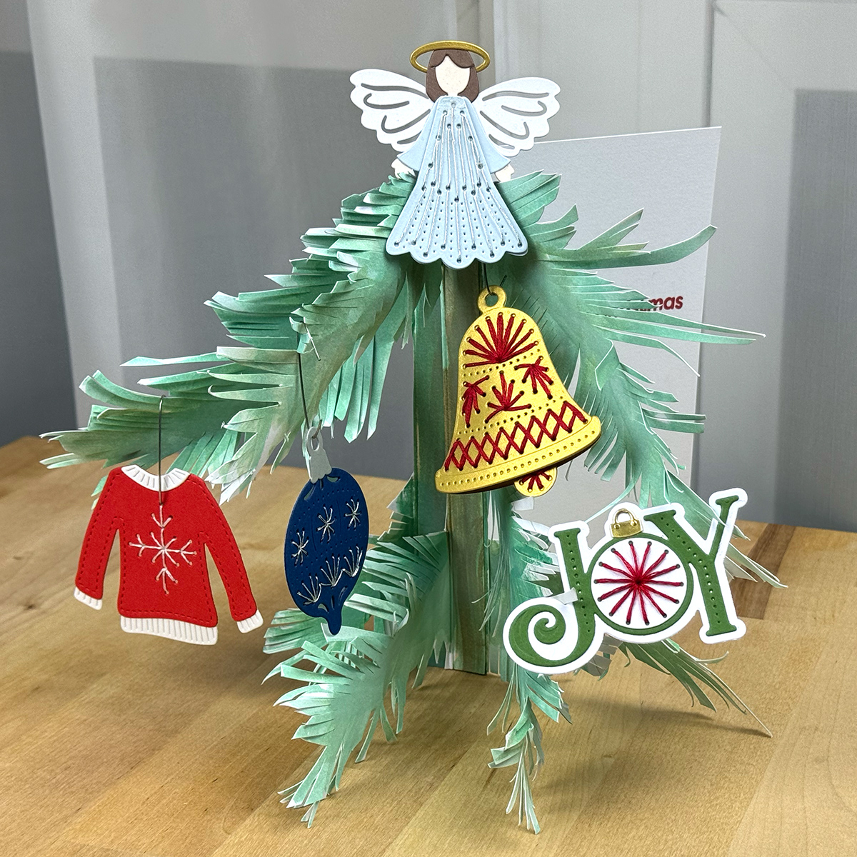 A christmas tree card with ornaments on it.