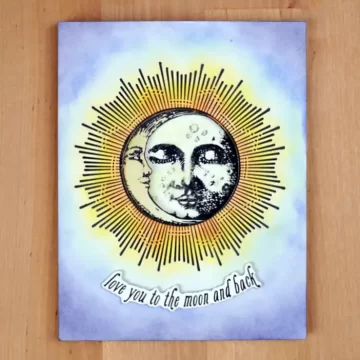 A greeting card with the face of the sun & the moon on it.