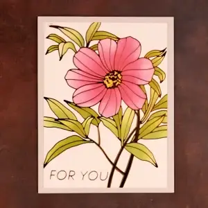 A pink flower with the words for you on it.