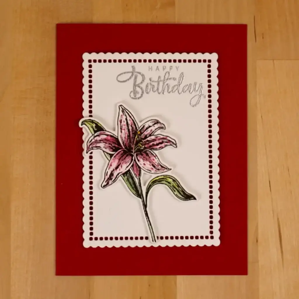 A birthday card with a pink Beautiful blooms lily on it.