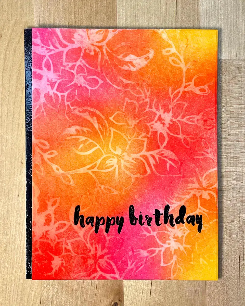 A colorful birthday card adorned with stamped images and the words "happy birthday.