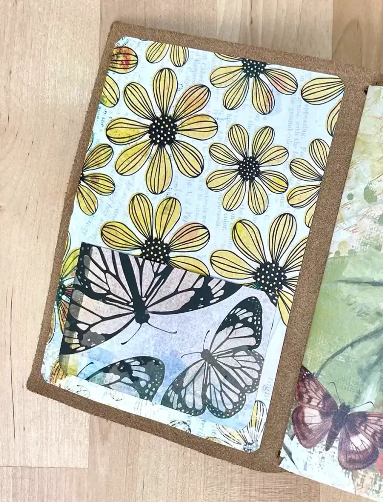A Crafters Traveler's Notebook adorned with butterflies and flowers.
