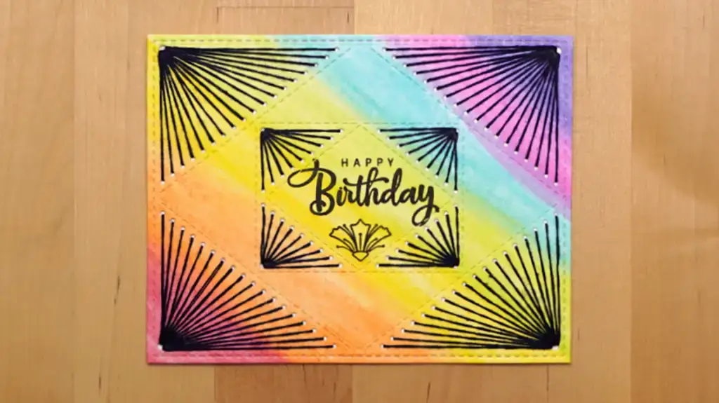 A colorful card with black stitching on it.