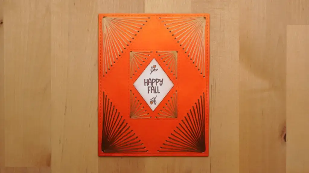 A card with a square design embellished with stitching.