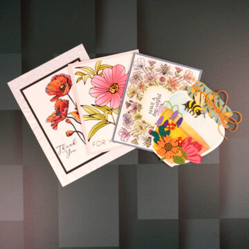 A set of cards with flowers and bees on them created with Spellbinders January Club kits.