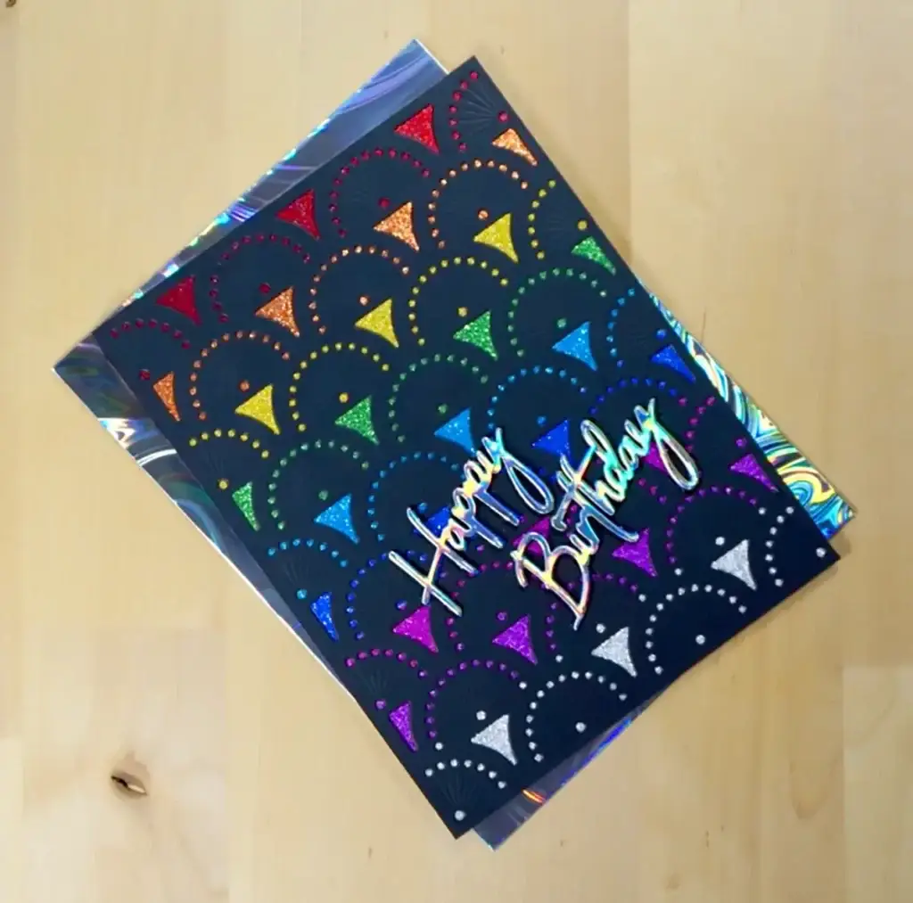 Spellbinders' New Release birthday card featuring a vibrant rainbow pattern.