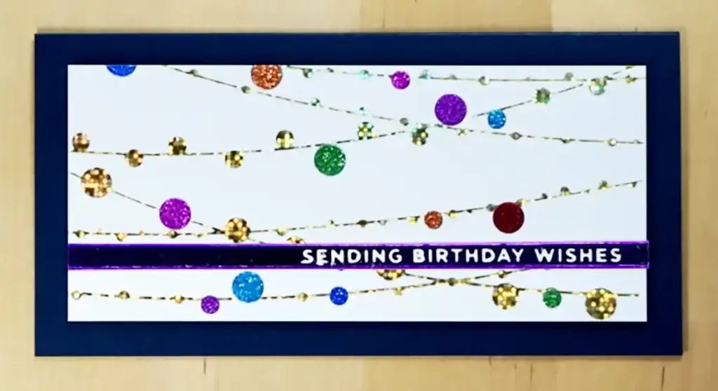Spellbinders' New Release features a birthday card adorned with a colorful string of lights.